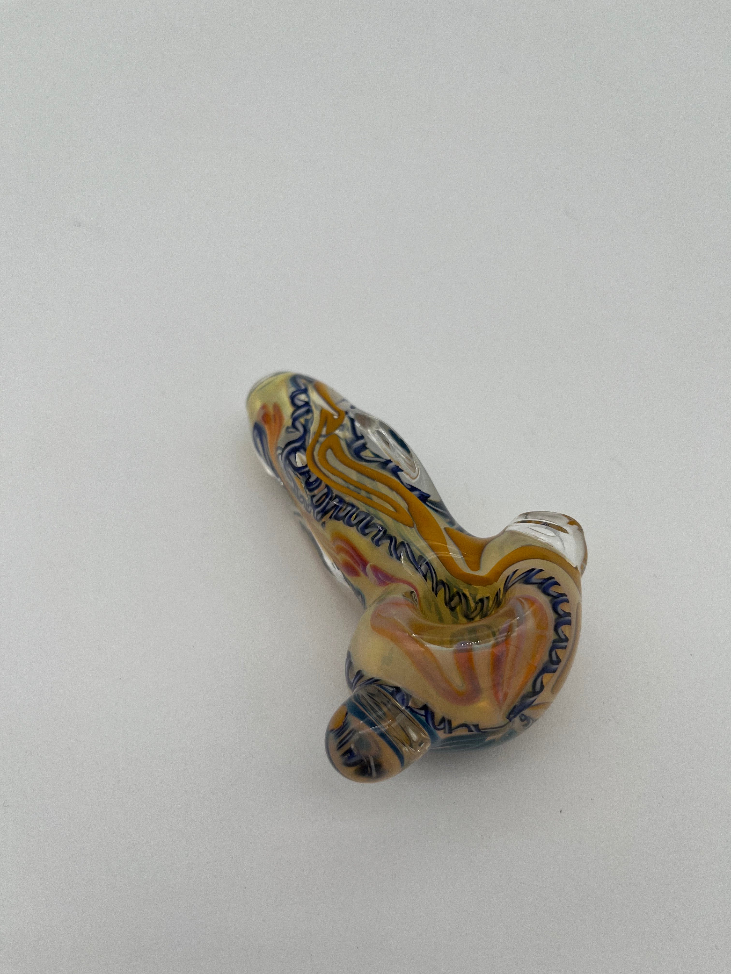 Blue and yellow inside out spiral glass hand pipe made by Nelson Glassworks on a white background. 