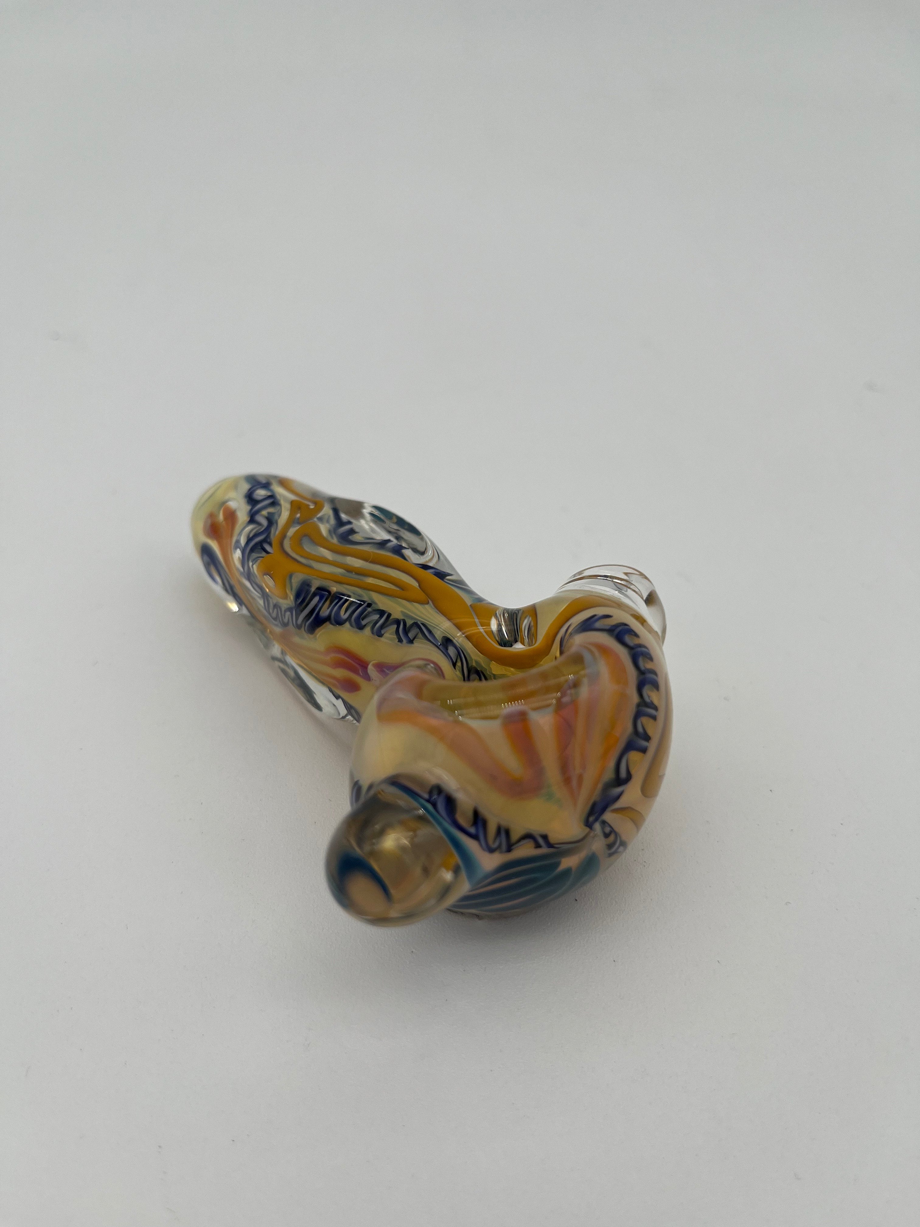 Blue and yellow inside out spiral glass hand pipe made by Nelson Glassworks on a white background. 