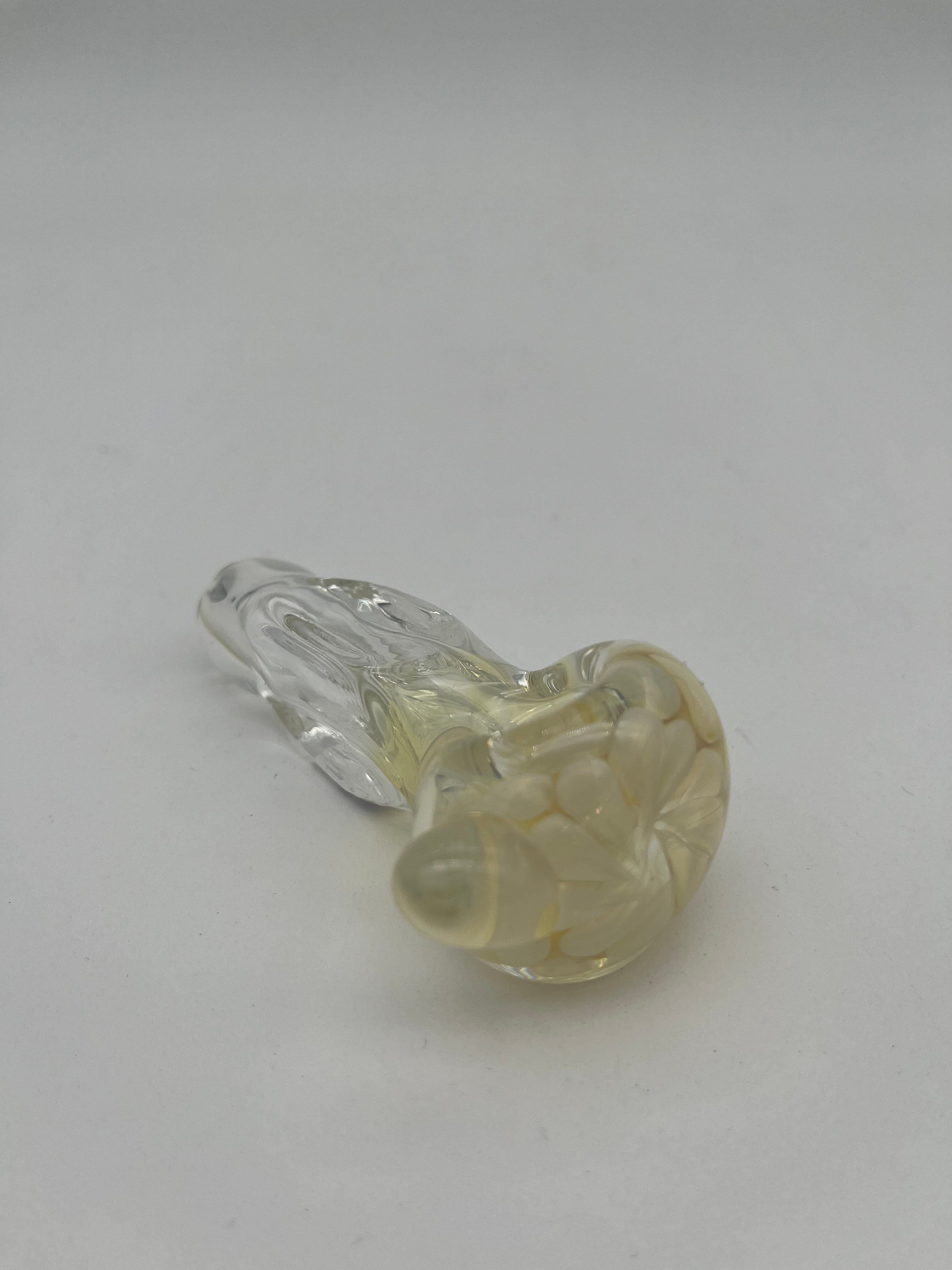 Clear and white floral looking glass pipe made by Nelson Glassworks on a white background.