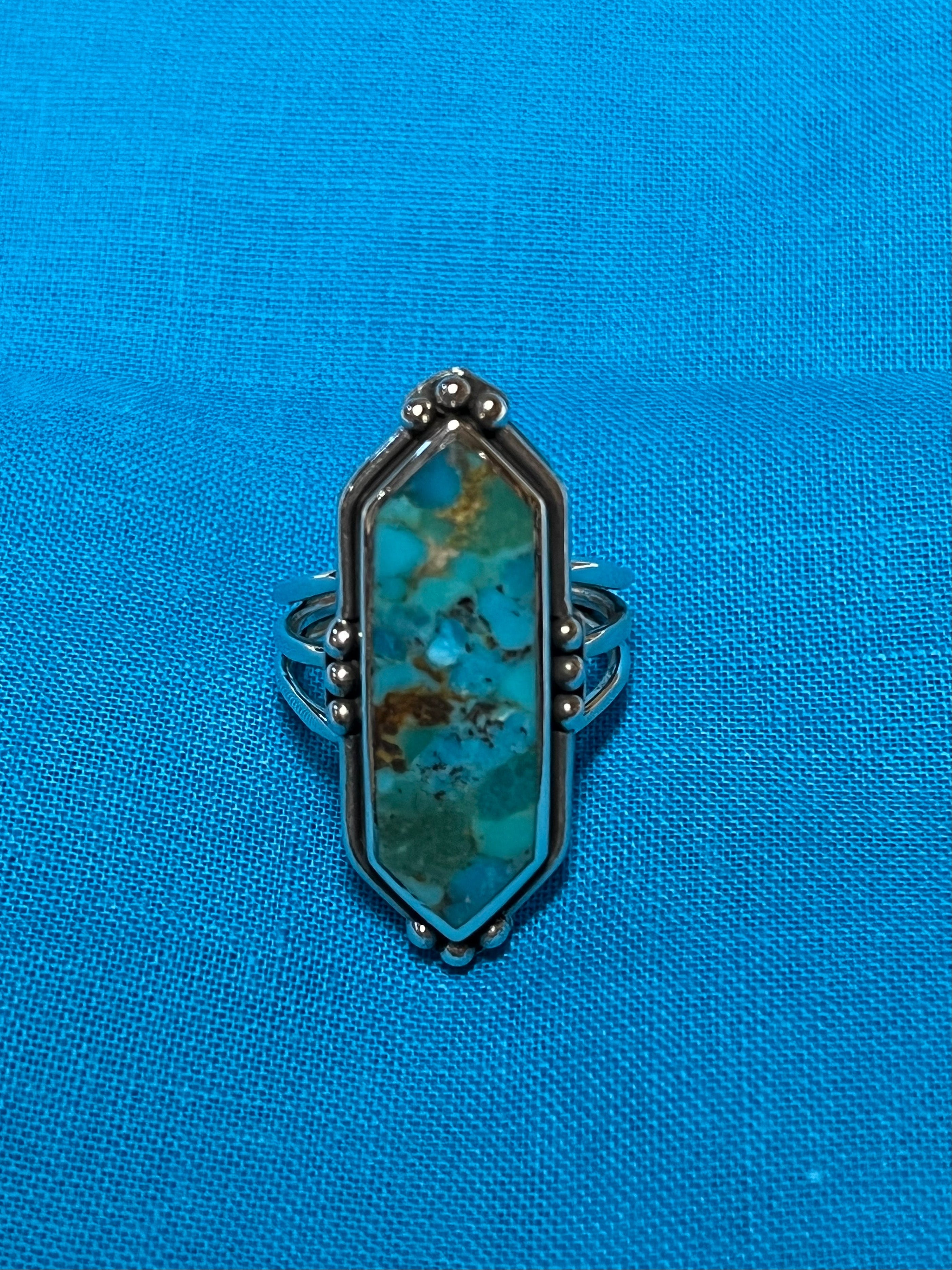 Turquoise inset silver ring. Hexagon shaped crystal turquoise inset. Blue background. Sterling 925 stamped silver ring.