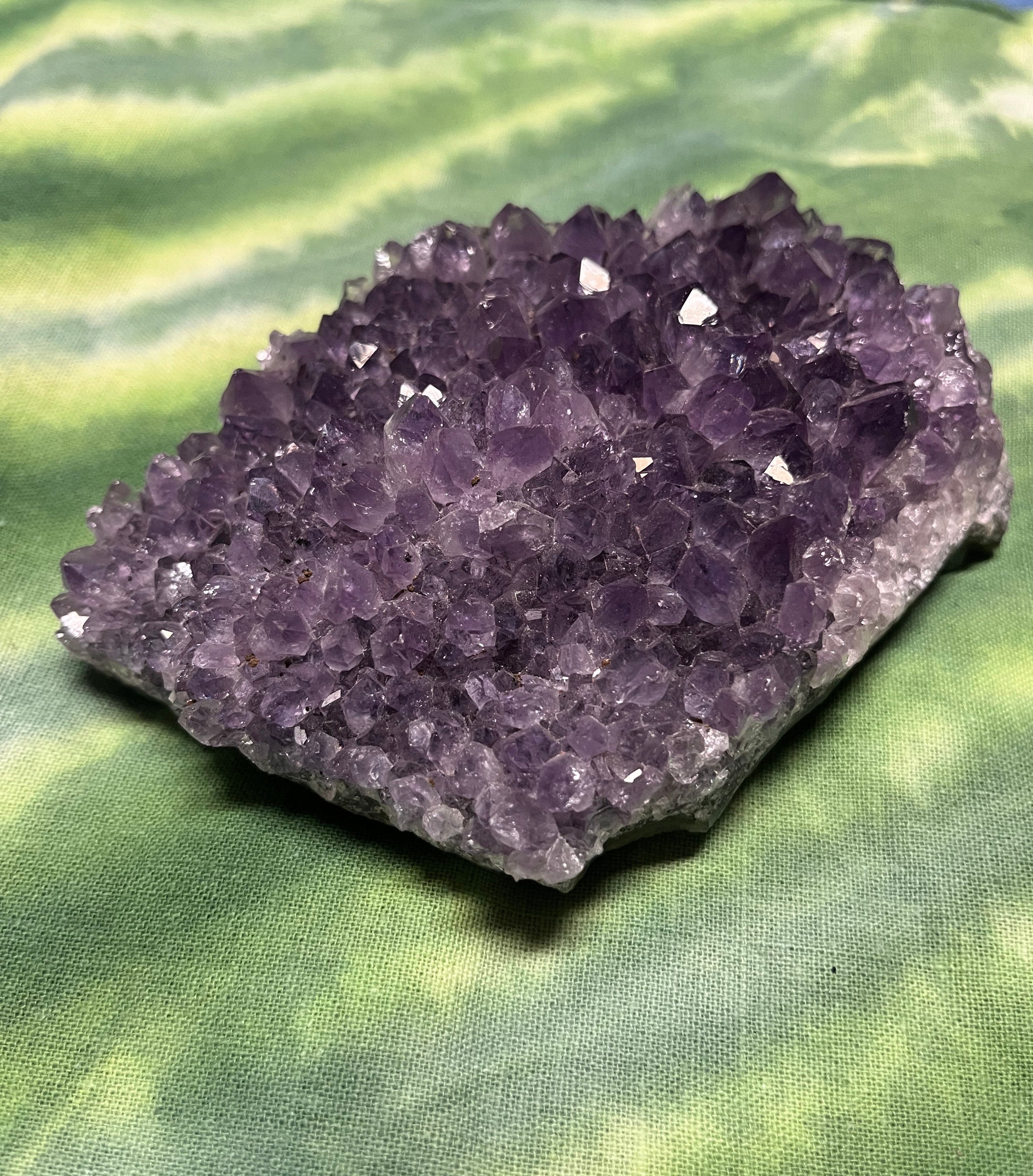 Amethyst crystal cluster on a green leaf